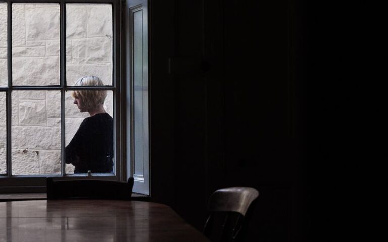 Lady standing outside window captured