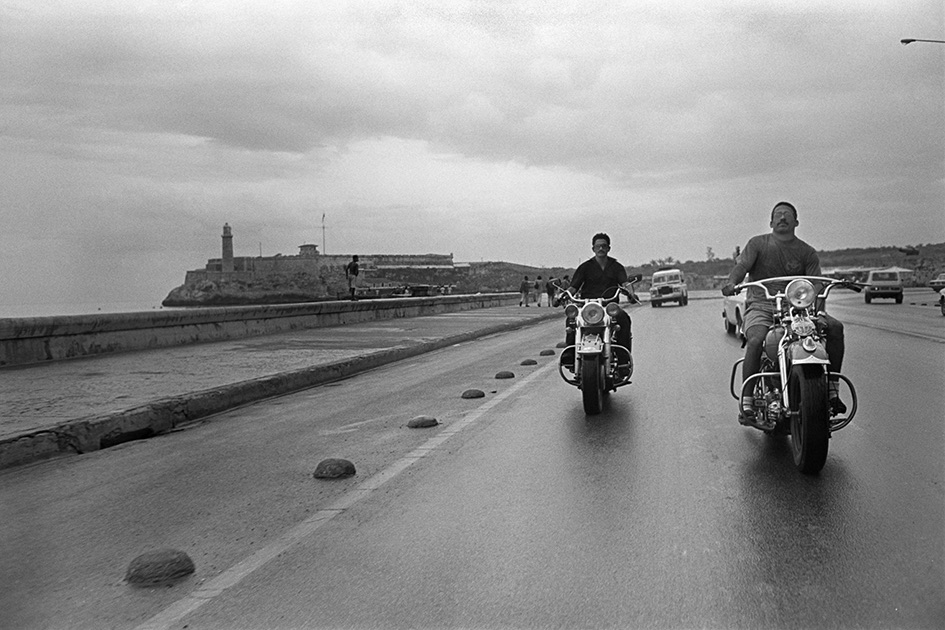 black and white image of men riding