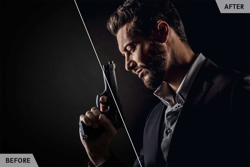 Brave cool man holding a gun on dark background