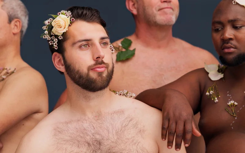 nude wedding photography- couple holding a wine class