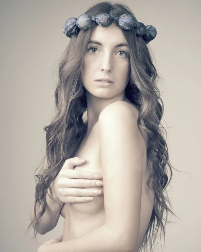 naked model with a hat and holding stick in her hand