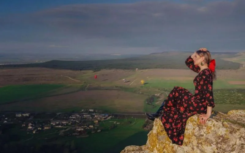 woman sitting on a rock