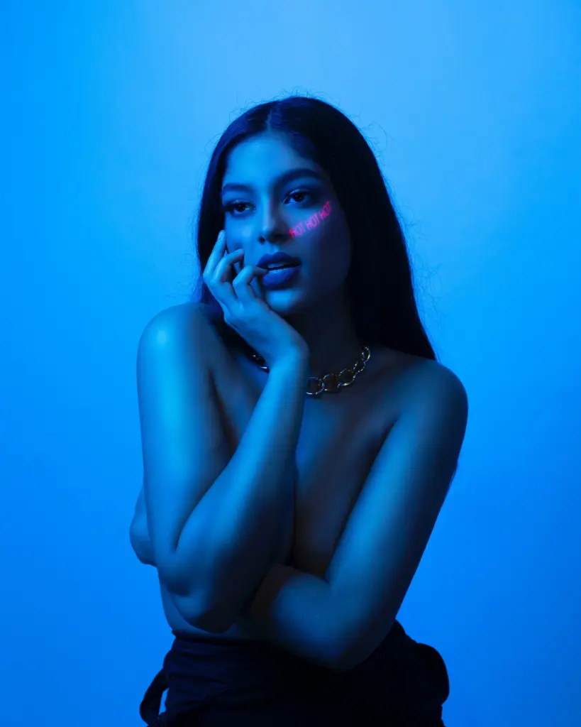 topless woman posing in blue light