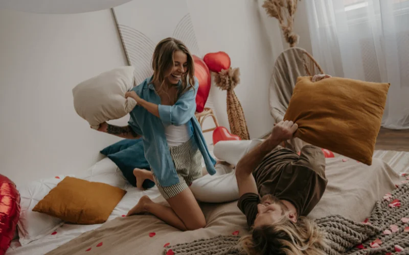 pillow fight bed poses for photoshoot, cozy vibes photoshoot