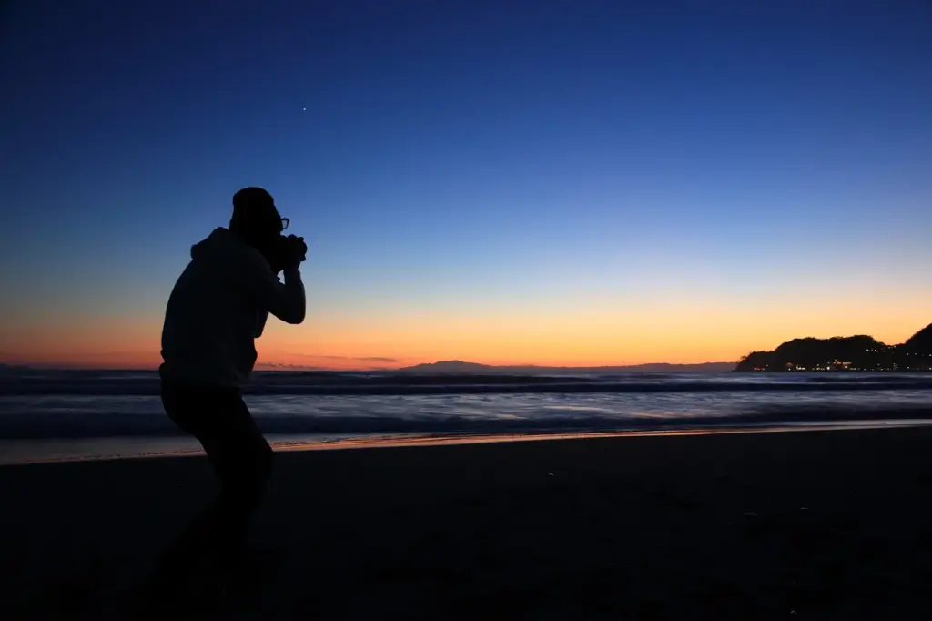a photographer clicking a sunrise photo