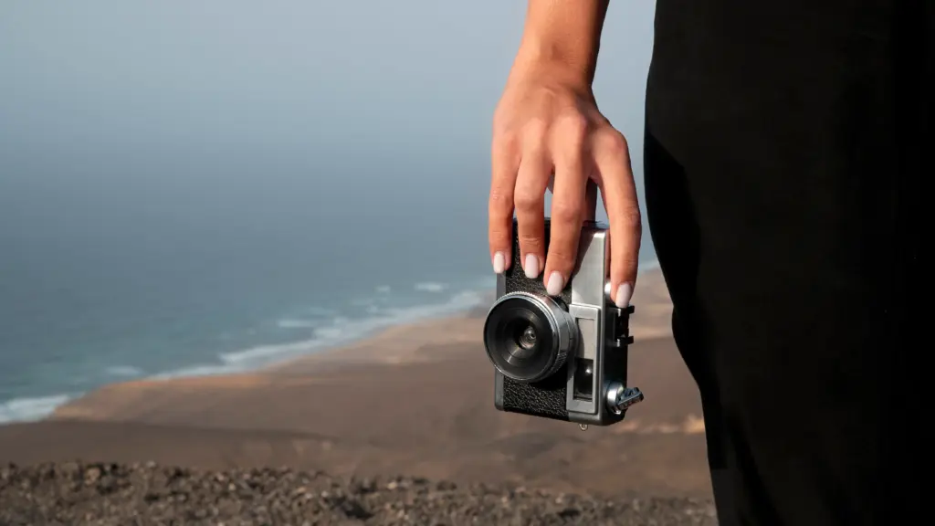 Women's hand holding a camera