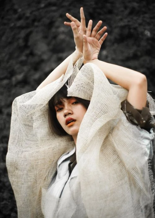 lady raising her hands for photoshoot - posing techniques for photographing model portfolios