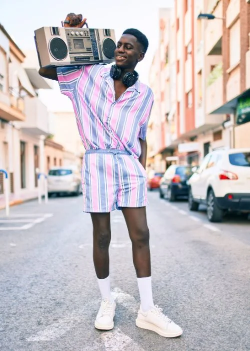 man holding a music player on his shoulder - photoshoot posing tips