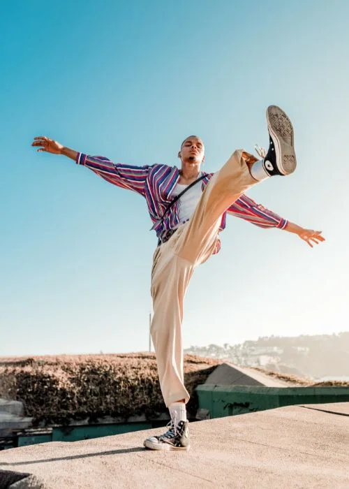 a man posing with his leg in the air