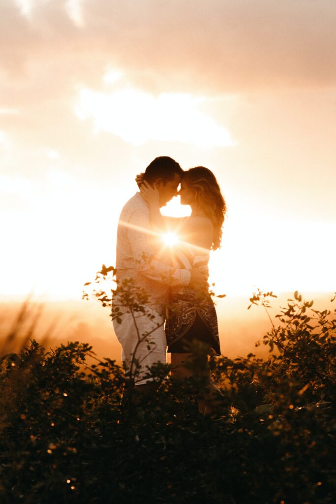 Couple posing and sunset coming from behind