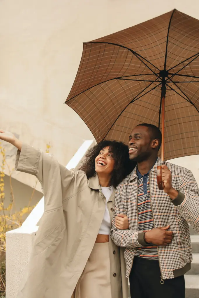 Couple posing under a umbrella
