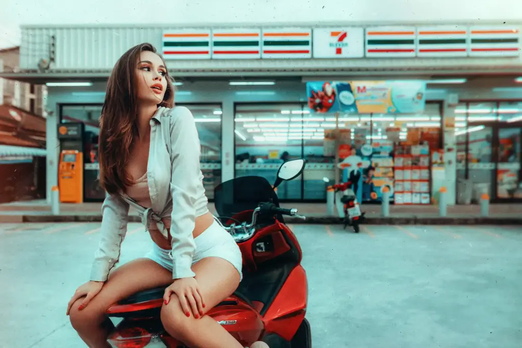 woman posing playfully on a scooter