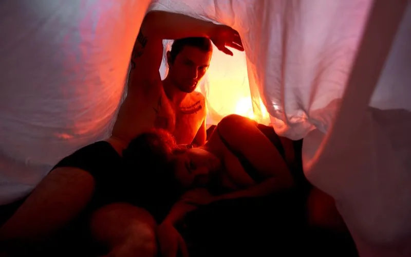 couple posing under the sheet