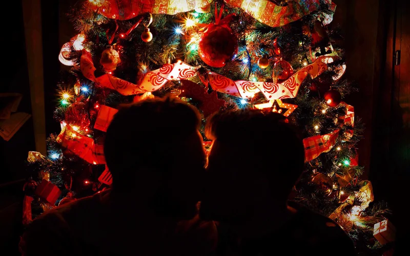 couple kissing near the Christmas tree