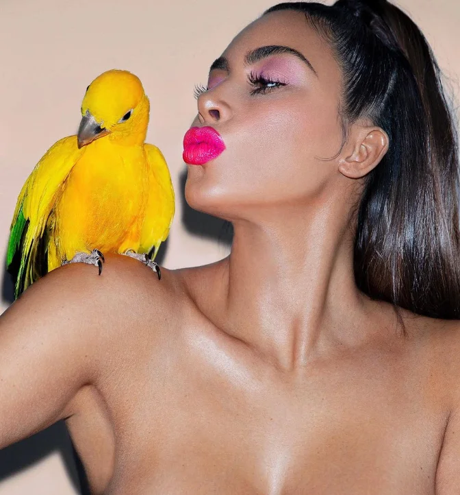 kim kardashian posing with a parrot