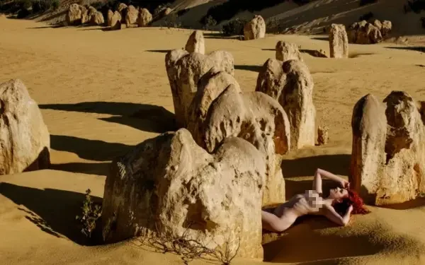 a woman posing naked in the desert