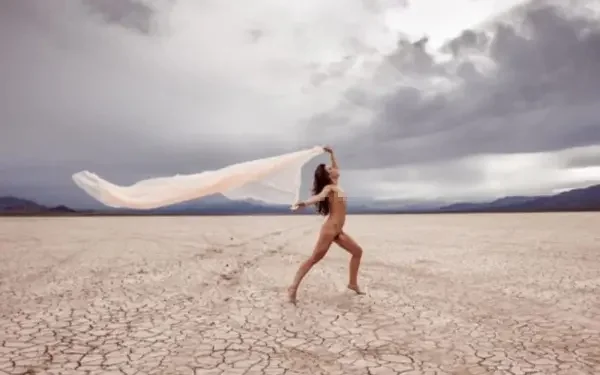 woman posing nude in a deserted area