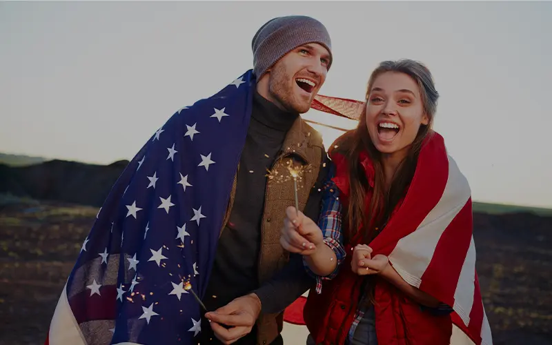 Couple with US flag wrapped around them