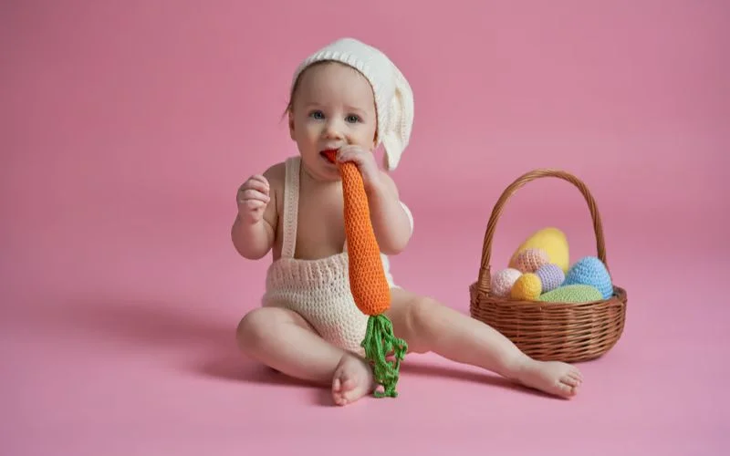 Baby munching a carrot