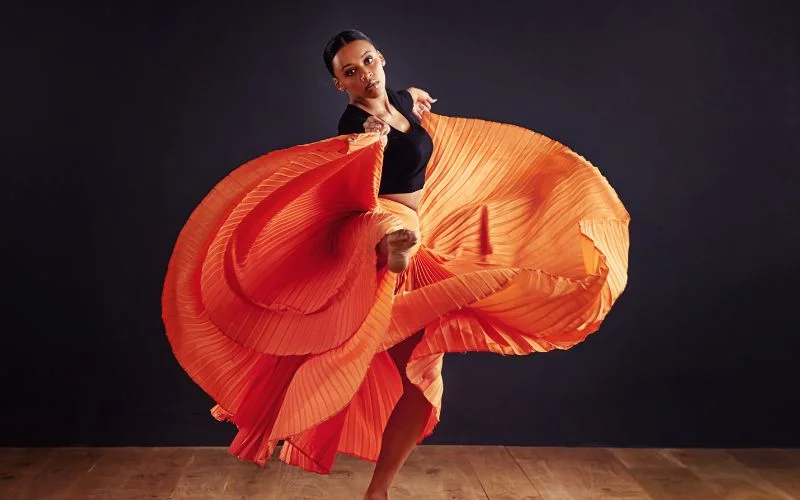 a lady dancing with a fabric