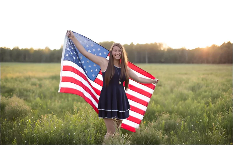girl holding flag on 4th July