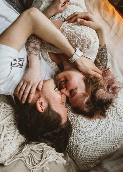 a couple posing on a bed