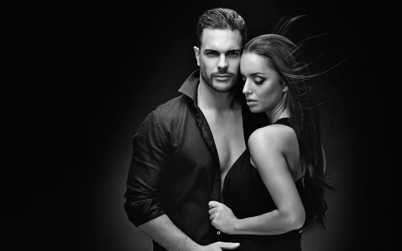 a black and white photo of a couple posing