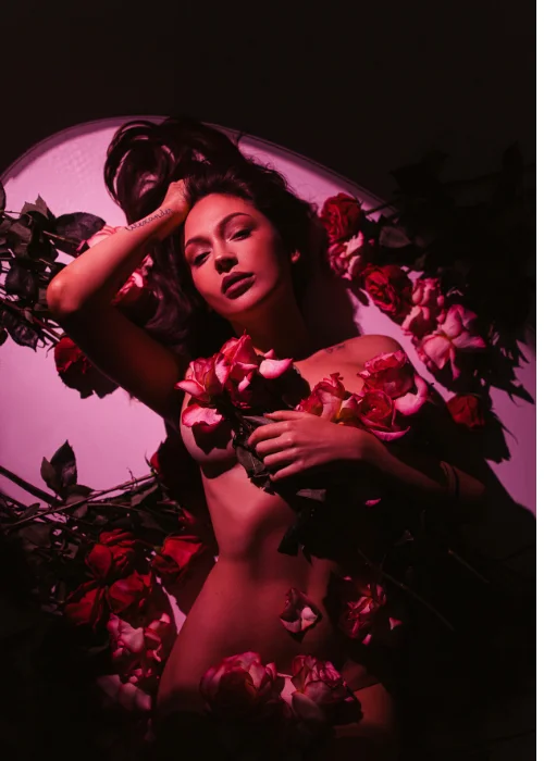 woman posing nude under roses