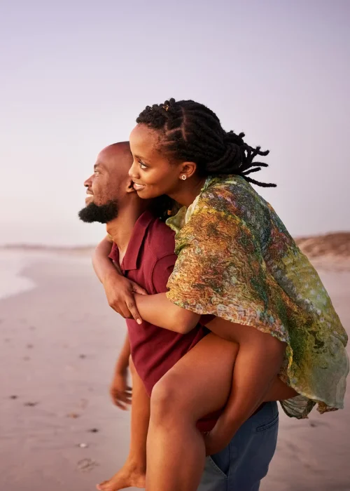 a man giving a piggy back ride to his partner