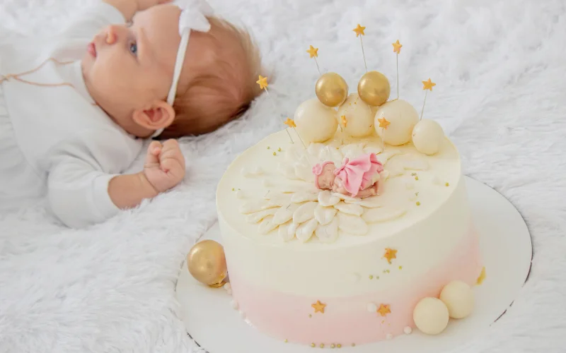 baptism photoshoot with baby and cake