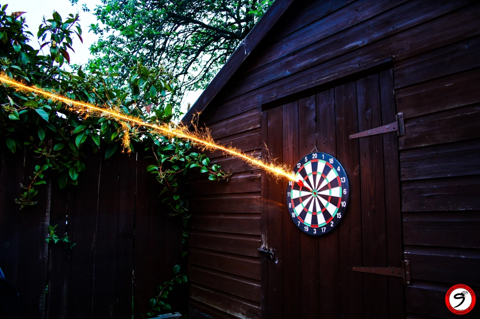 Artistic darts trajectory photo with sparkler