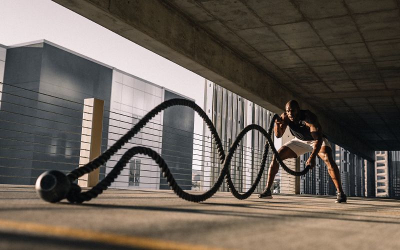 Man exercising with the ropes