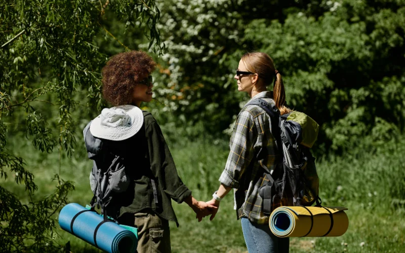 hikers walking while holding hands pose