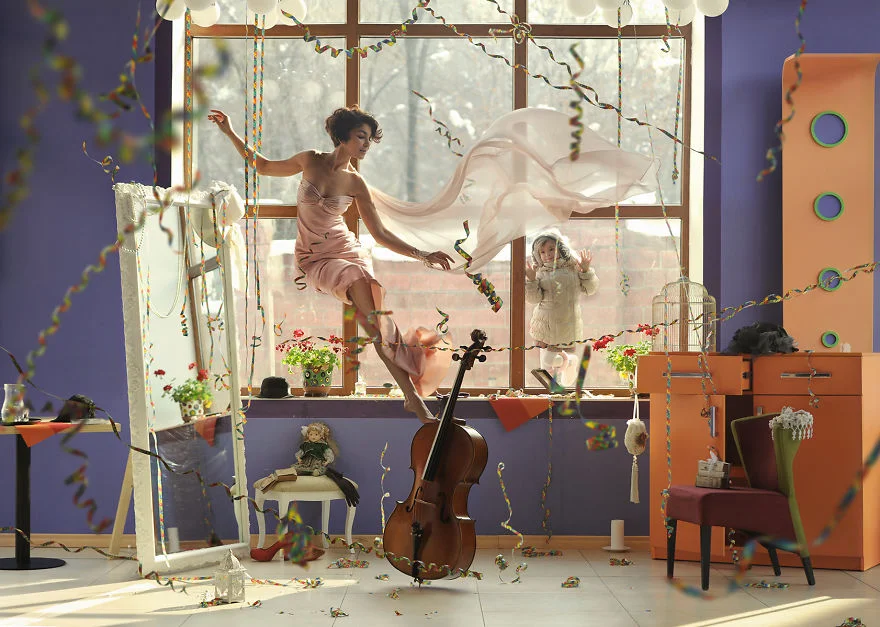 a woman flying in the air while a child looks through the window