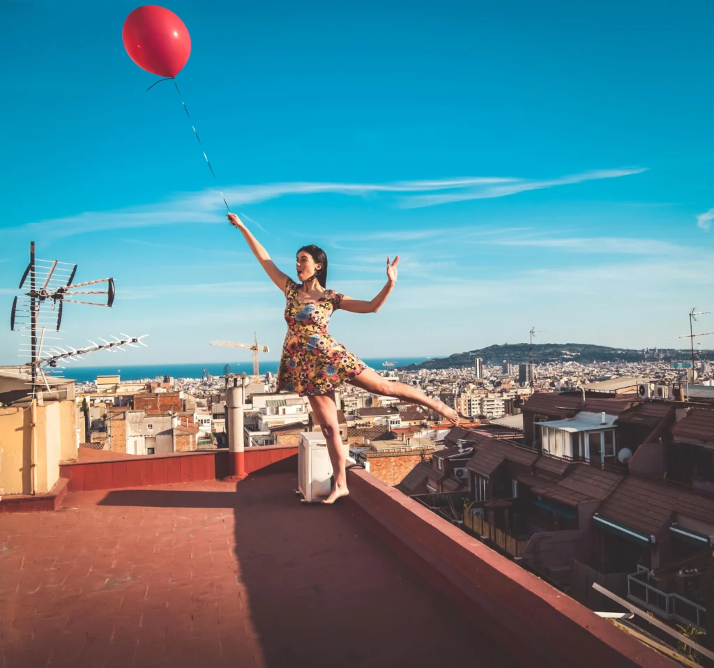 a woman flying with a balloon in hand