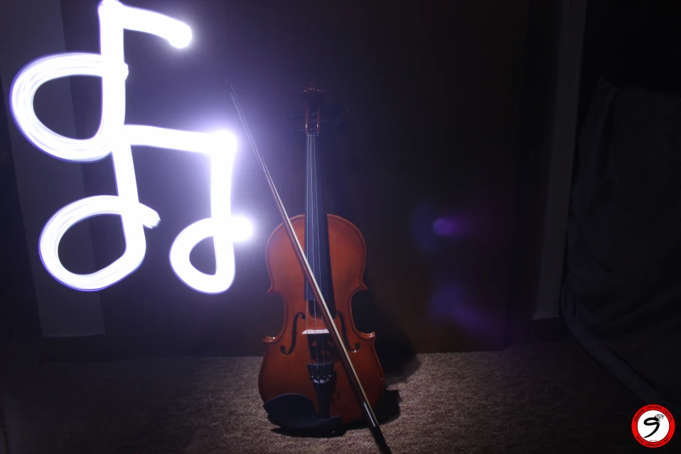 Imaginative light painting of musical note with a violin