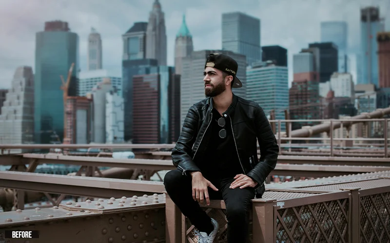 photo of a man sitting in a city