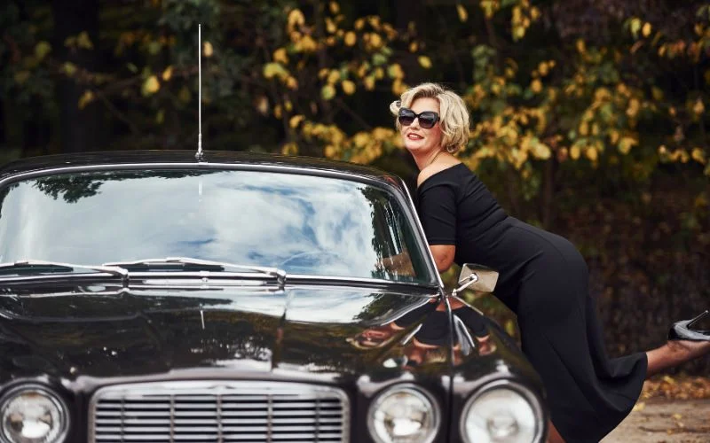 vintage car photoshoot ideas - a model posing in a glamourous outfit