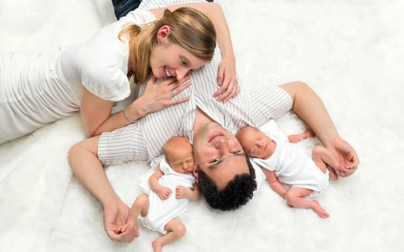 couple posing with newborn twins