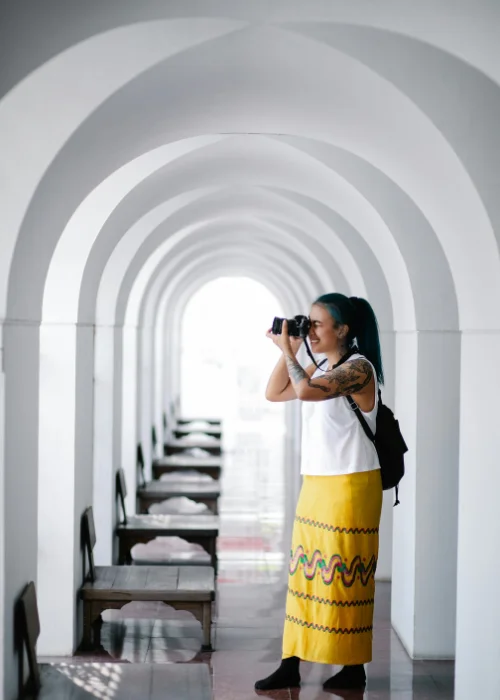 a woman posing in a corridor full of arcs