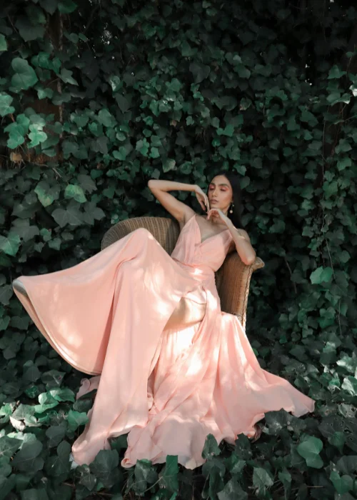 a model posing while surrounded by leaves
