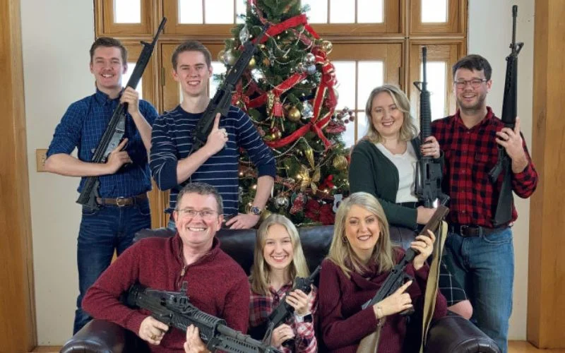 family holding guns in their hands