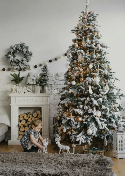 a Child playing next to the Christmas tree