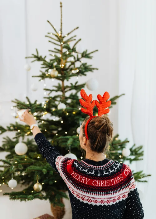 Woman decorating Christmas tree