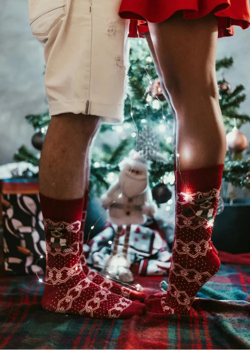 a woman tiptoeing in festive socks