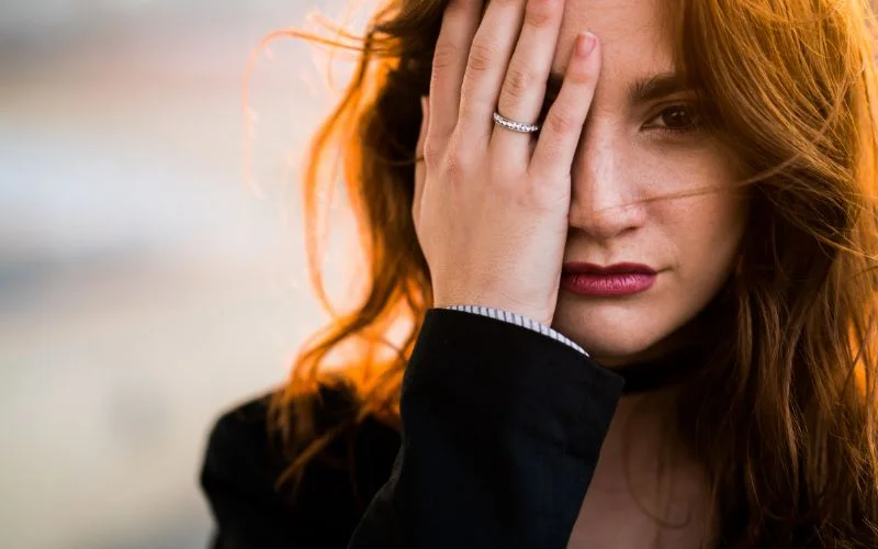 hand touching face pose