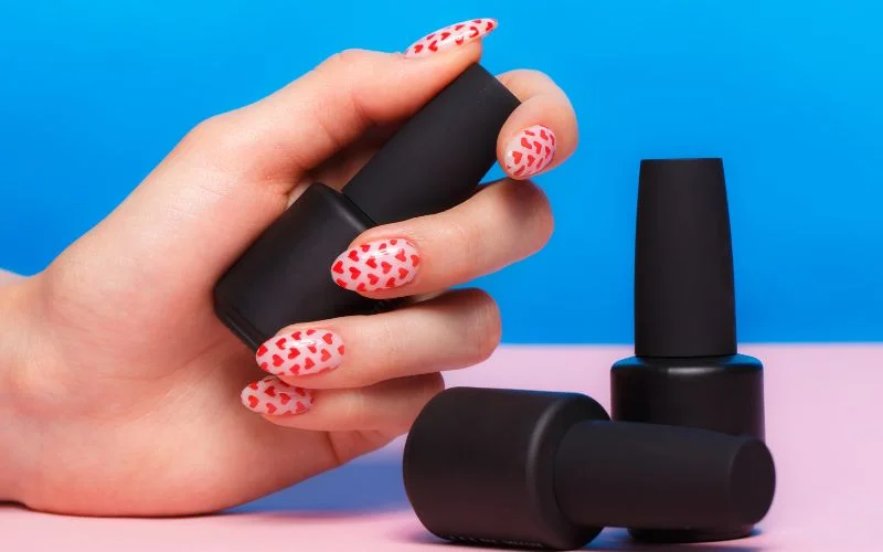 nail art hand pose holding nailpolish bottle