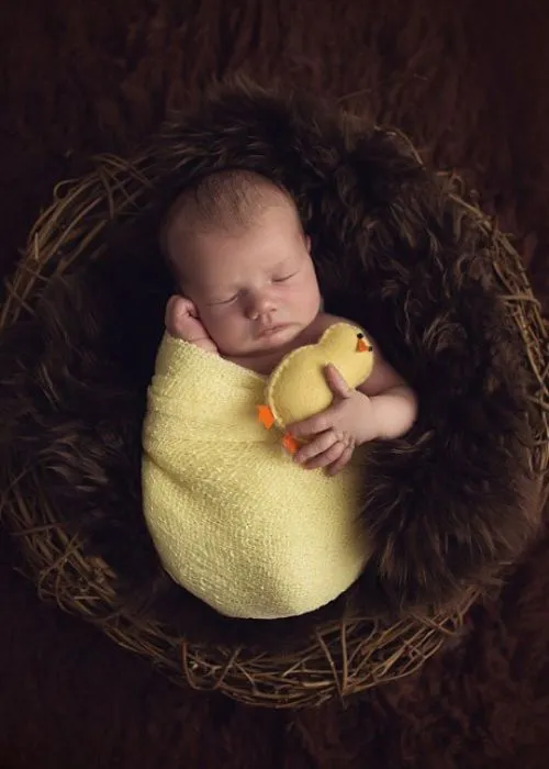 easter infant photo ideas of a baby sleeping in a nest, soft and dreamy easter photos, baby in bunny outfit photography