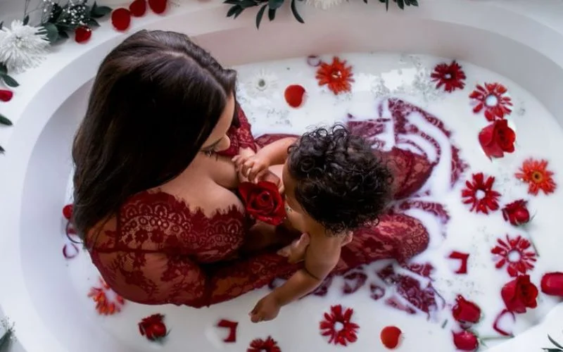 mother and child in a milk bath tub
