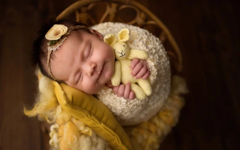 photo of a child with stuffed bunny, infant and plush bunny photography, baby bunny lovey photoshoot